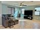 Inviting living room with a ceiling fan, tile flooring, and comfortable seating area at 15704 W Taylor St, Goodyear, AZ 85338