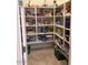 Walk-in pantry featuring ample shelving space for organized storage of food and household items at 15704 W Taylor St, Goodyear, AZ 85338