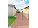 Side yard with rock, grass and a block wall at 15704 W Taylor St, Goodyear, AZ 85338