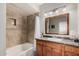 Bathroom with tub, shower, granite countertop, and wood cabinets at 16013 S Desert Foothills Pkwy # 2095, Phoenix, AZ 85048