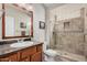 Bathroom with shower, granite countertop, and wood cabinets at 16013 S Desert Foothills Pkwy # 2095, Phoenix, AZ 85048