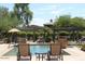 Relaxing pool area with lounge chairs and umbrellas at 16013 S Desert Foothills Pkwy # 2095, Phoenix, AZ 85048