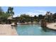 Community pool with a water feature and lounge chairs at 16013 S Desert Foothills Pkwy # 2095, Phoenix, AZ 85048