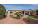 Landscaped backyard with a patio and seating area at 16043 W Copper Crest Ln, Surprise, AZ 85374