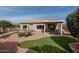 Spacious backyard with patio, grass, and fire pit at 16043 W Copper Crest Ln, Surprise, AZ 85374