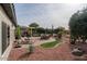 Landscaped backyard with patio furniture and a fire pit at 16043 W Copper Crest Ln, Surprise, AZ 85374