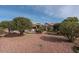 Large backyard with desert landscaping and a patio at 16043 W Copper Crest Ln, Surprise, AZ 85374