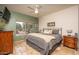 Spacious bedroom with king-size bed, ceiling fan, and large window at 16043 W Copper Crest Ln, Surprise, AZ 85374