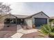 Single story home with gray exterior, terracotta roof and desert landscaping at 16043 W Copper Crest Ln, Surprise, AZ 85374