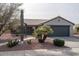 Single-story home with gray exterior, terracotta roof, and desert landscaping at 16043 W Copper Crest Ln, Surprise, AZ 85374