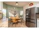 Kitchen nook with a table and chairs, overlooking the backyard at 16043 W Copper Crest Ln, Surprise, AZ 85374