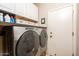 Laundry room with Whirlpool washer and dryer, and ample cabinet storage at 16043 W Copper Crest Ln, Surprise, AZ 85374