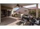 Outdoor kitchen and patio area with seating and a built in grill at 16043 W Copper Crest Ln, Surprise, AZ 85374