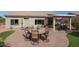 Large backyard patio with seating, fire pit, and outdoor kitchen at 16043 W Copper Crest Ln, Surprise, AZ 85374