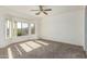 Spacious bedroom featuring a bay window and ceiling fan at 16331 W Willow Creek Ln, Surprise, AZ 85374