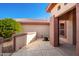 Charming courtyard with neutral exteriors, complemented by green bushes and an artistic potted plant at 16331 W Willow Creek Ln, Surprise, AZ 85374