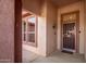 Covered front porch leads to security screen front door and sidelight window at 16331 W Willow Creek Ln, Surprise, AZ 85374