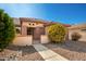 Landscaped front yard with a walkway to the entrance at 16331 W Willow Creek Ln, Surprise, AZ 85374