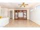 Spacious living room featuring a built-in entertainment center and neutral tile flooring at 16331 W Willow Creek Ln, Surprise, AZ 85374