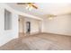 Spacious living room with neutral carpet flowing into tiled entry and an open layout for flexible use at 16331 W Willow Creek Ln, Surprise, AZ 85374