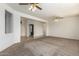 Spacious living room with neutral carpeting and ceiling fans at 16331 W Willow Creek Ln, Surprise, AZ 85374