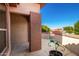 Side patio with a decorative metal plant holder and wall at 16331 W Willow Creek Ln, Surprise, AZ 85374