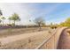 Wide community sidewalk with desert landscaping under a blue sky at 16331 W Willow Creek Ln, Surprise, AZ 85374