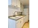 White kitchen with double sink, dishwasher, and ample cabinet space at 1701 E Colter St # 421, Phoenix, AZ 85016