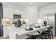 Modern kitchen with island, white cabinets, and stainless steel appliances at 17735 W Mission Ln, Waddell, AZ 85355