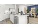 Modern kitchen island with stainless steel dishwasher at 17735 W Mission Ln, Waddell, AZ 85355