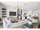 Living room with modern furniture and a large TV at 17735 W Mission Ln, Waddell, AZ 85355