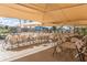 Community patio with tables and chairs under shade structure at 1841 E Augusta Ave, Chandler, AZ 85249