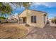 View of the home's backyard showcasing desert landscaping and a covered patio at 1851 W Pelican Dr, Chandler, AZ 85286