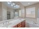 Elegant bathroom featuring double sinks, a soaking tub, and a glass-enclosed shower, offering a spa-like experience at 1851 W Pelican Dr, Chandler, AZ 85286