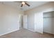 Neutral bedroom featuring a ceiling fan, closet, and attached bathroom, creating a comfortable and private space at 1851 W Pelican Dr, Chandler, AZ 85286