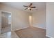 Neutral bedroom with carpet flooring, a ceiling fan, and a doorway leading to another bedroom at 1851 W Pelican Dr, Chandler, AZ 85286