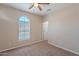 Bedroom features a neutral palette, arched window, and doorway to another room, creating a serene and adaptable space at 1851 W Pelican Dr, Chandler, AZ 85286