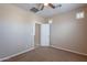 Neutral bedroom with a ceiling fan, door to another room and window with plantation shutters at 1851 W Pelican Dr, Chandler, AZ 85286