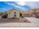 Charming single-story home with a two-car garage, desert landscaping, and a tile roof under a sunny sky at 1851 W Pelican Dr, Chandler, AZ 85286