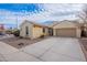 Charming single-story home with a two-car garage, desert landscaping, and a tile roof under a partly cloudy sky at 1851 W Pelican Dr, Chandler, AZ 85286