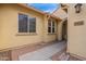 Close-up view of the home's entrance featuring a tile roof, desert landscaping, and an arched entryway at 1851 W Pelican Dr, Chandler, AZ 85286