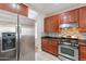 Kitchen featuring stainless steel appliances, granite countertops, and mosaic backsplash, with a stainless steel refrigerator at 1851 W Pelican Dr, Chandler, AZ 85286