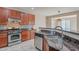 Kitchen featuring stainless steel appliances, granite countertops, backsplash and a large island with a sink at 1851 W Pelican Dr, Chandler, AZ 85286