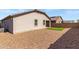 Rear exterior of home featuring artificial turf and gravel at 18819 W Cholla St, Surprise, AZ 85388