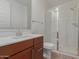 Modern bathroom with sleek vanity, quartz countertop, and glass-enclosed shower with subway tile at 18819 W Cholla St, Surprise, AZ 85388