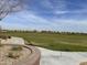 Beautiful green lawn in the community with a sidewalk and landscaped area, providing space for walking and activities at 18819 W Cholla St, Surprise, AZ 85388