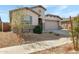 Well-maintained single-Gathering home with desert landscaping and a spacious driveway leading to a garage at 18819 W Cholla St, Surprise, AZ 85388