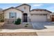 Charming single-Gathering home featuring stone accents, desert landscaping, and a two-car garage at 18819 W Cholla St, Surprise, AZ 85388