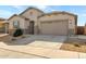 Charming single-Gathering home featuring stone accents, desert landscaping, and a two-car garage at 18819 W Cholla St, Surprise, AZ 85388