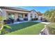 Artificial turf, patio furniture, and a built in grill highlight this backyard at 20508 W Carlton Mnr Mnr, Buckeye, AZ 85396